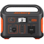 Close-up of a Jackery portable power station front panel with outlets and a digital display under a black casing and orange accents.