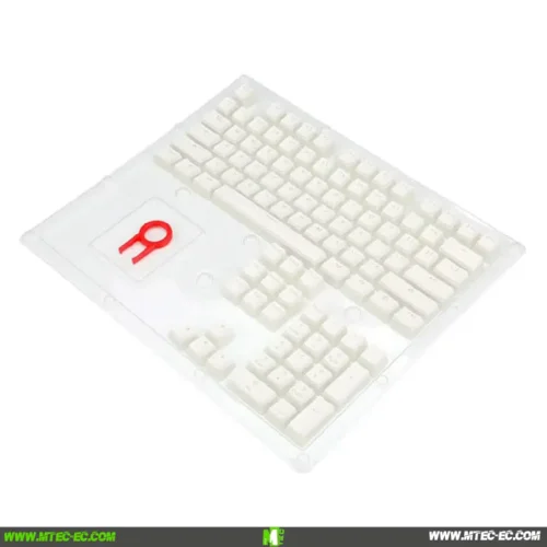 White keyboard sealed in clear plastic packaging, viewed at an angle.