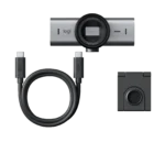 Logi webcam with accompanying USB-C cable and mounting clip laid out against black background, showing the lens, connection cable, and mount portion.