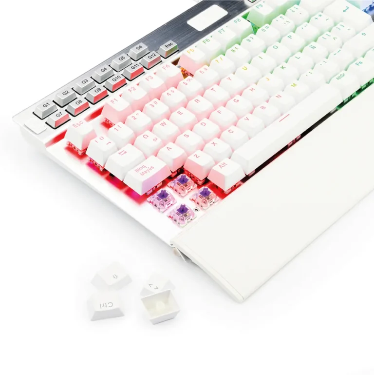 Close-up of a white mechanical keyboard with colorful RGB keycaps and several keys removed, exposing the switches beneath.